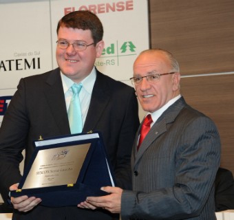 O presidente do Sescon-Serra Gaúcha, Tiago Dal Corno (esq.), recebe placa de Milton Corlatti.